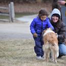 Bella, 4, and Marian Burgo pet the farm dog. 