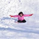 Rosalie Lavoie, 10, sleds backwards down the hill.