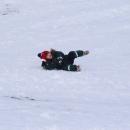 Hunter Fertig, 3, rolls around in the snow.