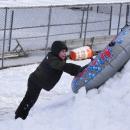 Andrew Robitaille, 6, tries to push his tube up a pile of snow.