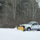 A UMass Dartmouth plow getting rid of the snow.