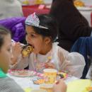 Dani Semedo, age 6, enjoys a cinnamon roll.