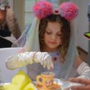Camila Sovik, age 6, stirs some sugar into her tea. Photos by Kat Sheridan