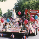 Image from Marion July 4th Parade from the Sippican Historical Society's archives showing girls holding balloons and streamers on a float.
