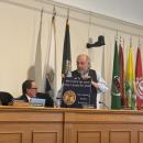 David Tatelbaum gifts Stanley Mickelson the illegally hung sign. 