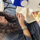 Photo of Claudia De Sousa Baptista mending clothing. Source: Marissa Perez Dormitzer