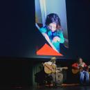 Leila Hijazi performs "Remember Me" from Encanto with photos of her as a child in the background.