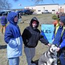 Some kids pet a dog at the protest.