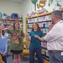 Emelia Goddard, Lily Weisberg, and Emma Dury present their project on Women's History in the curriculum to Ross Thibault.
