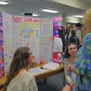 Rosanna Vargo and Lauren Rose-Wells present their project on body image to Heidi-Silva Brooks. 