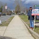 Al Oliveira campaigns outside Town Hall. 