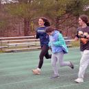 Delilah Dellecese runs alongside Hayden Barriteau and Etta Hall.