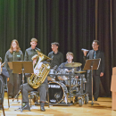 Students play the drums during the band concert. 