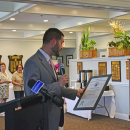 Cody Hadadd reads off some of Jackie McDonald's accomplishments. 