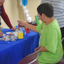 Jentzen, 11, makes some sand art. 
