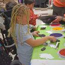 Miley, 2, makes stamp art at the Buttonwood Zoo table. 