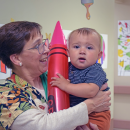 Julias, 11 months, holds a ballon crayon. 