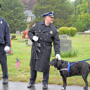 A member of the police pets a dog at the event. 