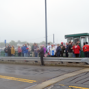 The crowd listens to a member of the Dartmouth Community Band perform "Taps."