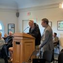 Michael Woyciechouski speaks with Town Counsel Anthony Savastano standing nearby. 
