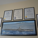 Citations and a painting of the Japanese battleship that Enos' submarine sunk. 
