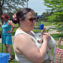 Rachel holding a baby goat.