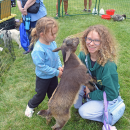 Ashley and Maliyah, age 3, pet a chewy goat. 