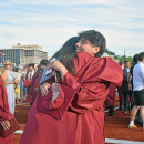 Two students hug.
