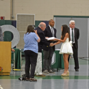 A student receives her diploma. 