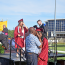 Stephanie Agbetorgoh's father kisses her forehead after she graduates. 