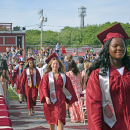 The students enter into the graduation. 