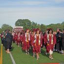 The students walk through the tunnel of faculty. 