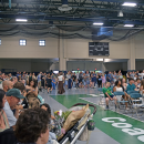 The crowd overspilled from the bleachers to the sides of the court. 