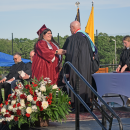 A student receives her diploma. 