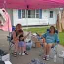 Destiny and Madeline pose at their yard sale.