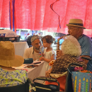 Gene Monteiro plays the saxophone for his aunt, while his granddaughter 'plays' alone. 