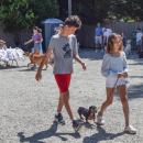Florie and her brother walk their dachshund. 
