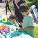 Joel, 8, and Lilia, 3, paint rocks at a craft station. 