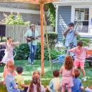 Two kids compete in a hula hoop contest held by the Toe Jam Puppet Band. 