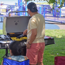 A man grills some squash. 