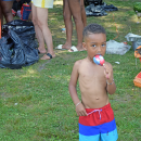A kid enjoys an ice pop. 
