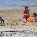 A group of girls plays in the sand. 