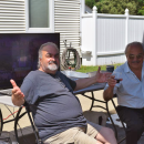 Two men pose for a photo. 