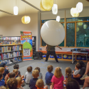 Jungle Jim climbing into the balloon to show the kids the dinosaur. Photos by Kat Sheridan