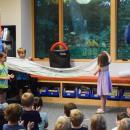 Arlo and Riley show off the dino they pulled from the bag. 