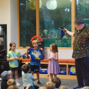 Grace, 7, Arlo and Riley participate in a magic act. Arlo accidentally pulled a chicken out of the bag, not a dino. 