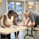 Guests sign the poster with letters to loved ones. 