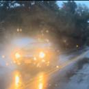 A car driving through a puddle. 