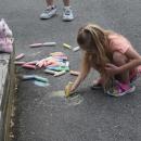 Autumn, age 5, draws some sunshine on the playground. 
