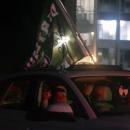 Fans with a Dartmouth flag out their sunroof. 